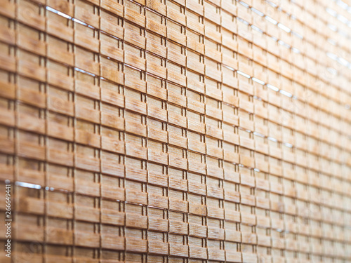 Closeup wooden blind textures with yellow sunlight in cafeteria.