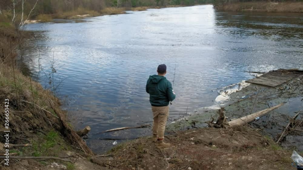 Mature man catches fish on the river. Mature man catches fish on the river.