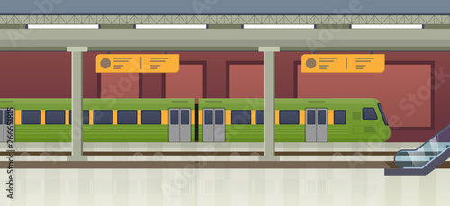 Interior of underground metro station, railway platform, train approaching station.