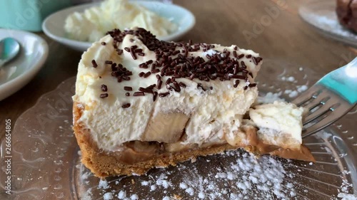 fork taking a piece of banoffee pie away to eat. photo