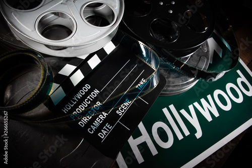 Tablou canvas Multiple film reels and a clapboard on a wooden background