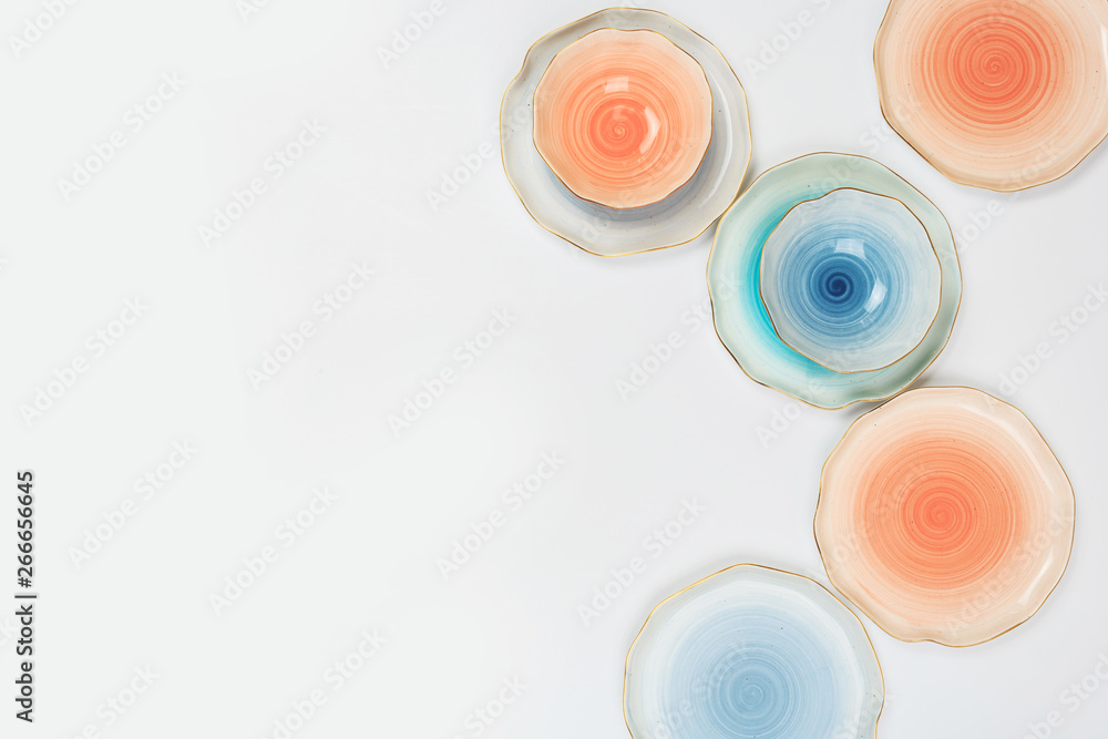 Set of colored ceramic plates on white background Set of colored ceramic plates on white background