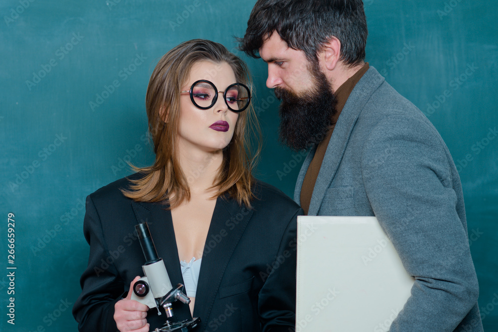 Student with sexy breast seduces teacher. The workplace romance trick.  Dating. Teacher with sexy female student. Young attractive teacher pointing  at chalkboard. foto de Stock | Adobe Stock