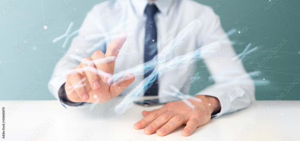Businessman holding a Group of chromosome with DNA inside isolated on a background 3d rendering Businessman holding a Group of chromosome with DNA inside isolated on a background 3d rendering