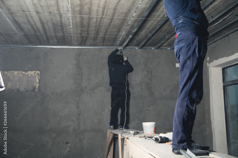 Working with a metal profile of a ceiling construction. Working with a metal profile of a ceiling construction.