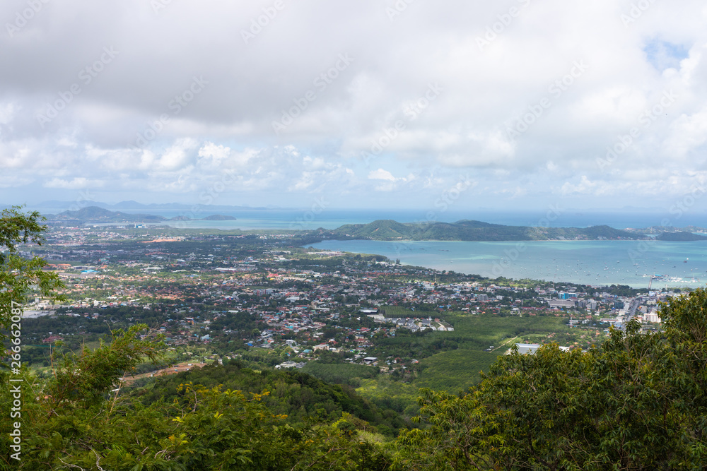 Phuket city scape from high hill ground, can see both town and the beach with cloudy sky