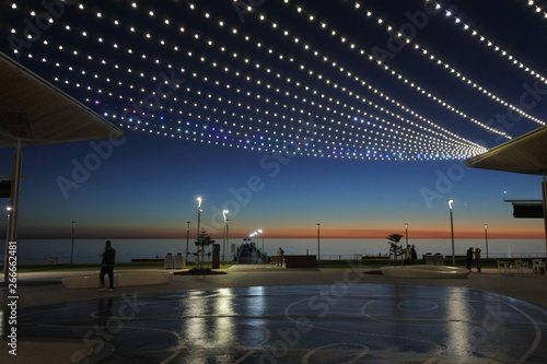 ADELAIDE - MAY 06 2019:Silhouette of Henley Beach pier and square at dusk. Henley Beach pier is a very popular tourist attraction and sightseeing in Adelaide the capital city of South Australia. a photo