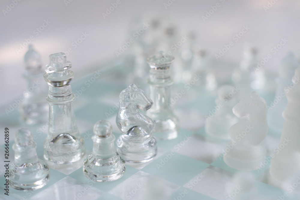 Chess board game made of glass, business competitive concept Chess board game made of glass, business competitive concept