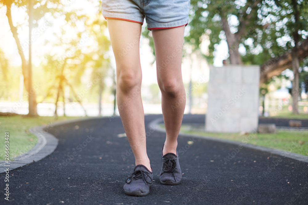 Close up foot. Girl is walking on the street in the park. Close up foot. Girl is walking on the street in the park.