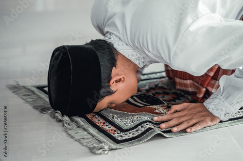 religious islamic muslim asian man praying to god photo