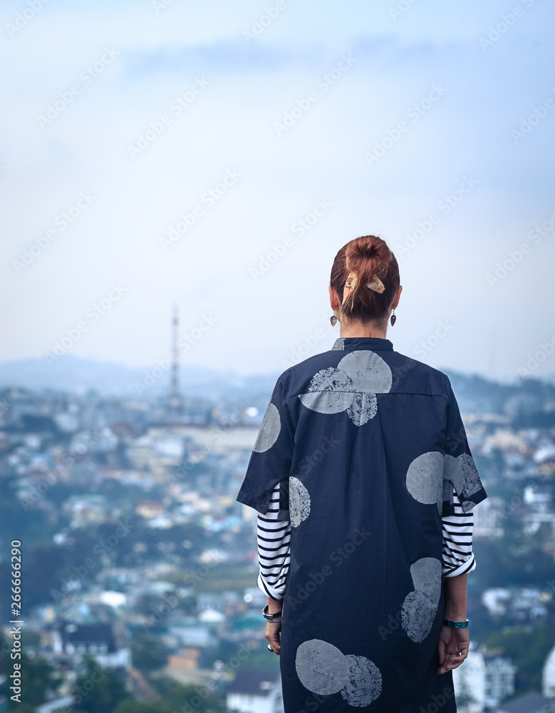 Woman overlooking the city view, Dalat, Vietnam Woman overlooking the city view, Dalat, Vietnam