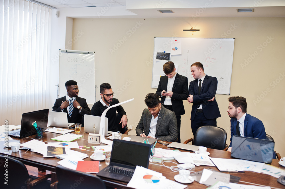 Six multiracial business mans at office at table. Diverse group of male employees in formal wear discussing. Six multiracial business mans at office at table. Diverse group of male employees in formal wear discussing.