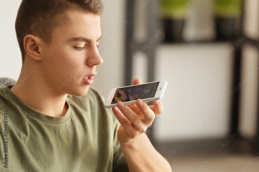 Teenage boy using application of smart home automation Teenage boy using application of smart home automation