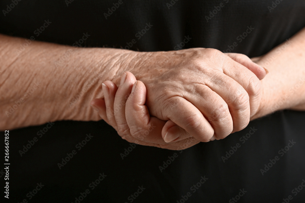 Hands of senior woman on dark background Hands of senior woman on dark background
