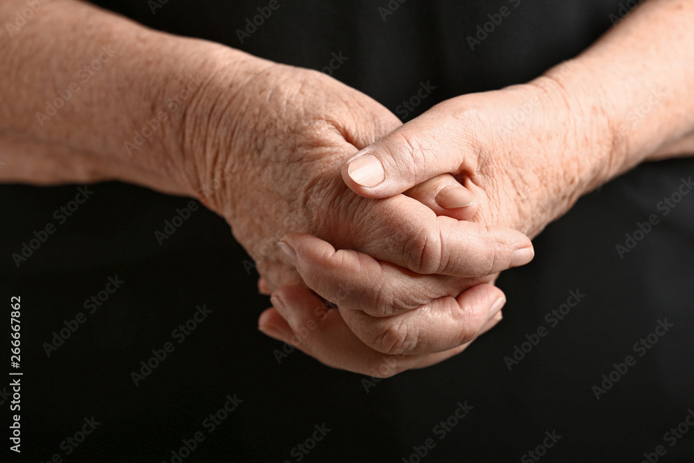 Hands of senior woman on dark background Hands of senior woman on dark background