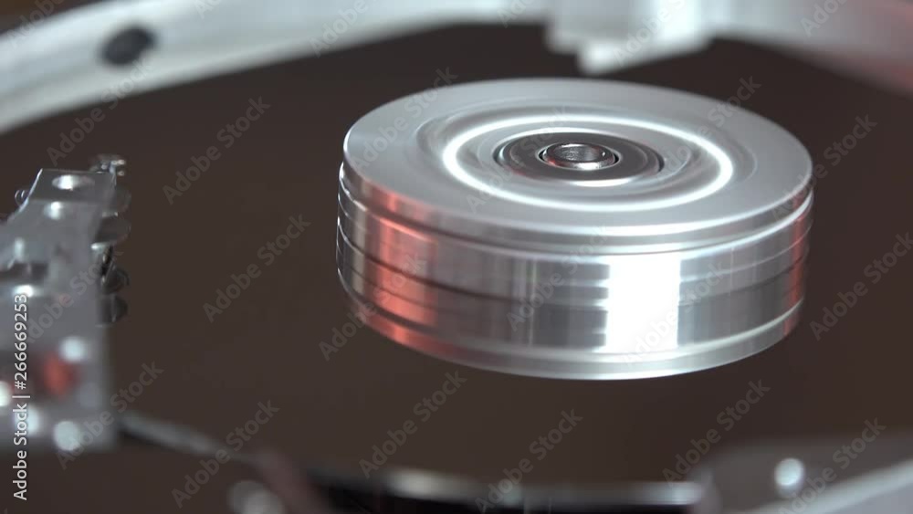 Close-up of an operating computer harddisk reading and writing data Close-up of an operating computer harddisk reading and writing data
