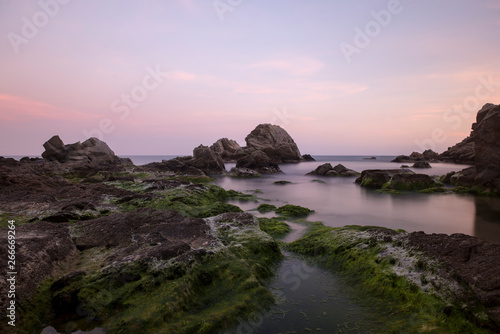 Beach and rocks at sunset in Lloret de Mar © vicenfoto