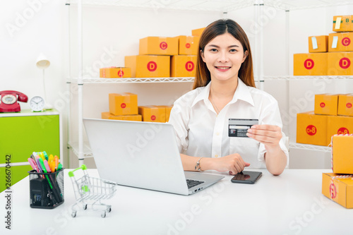 women working laptop computer from home on wooden floor with postal parcel, Selling online ideas concept, Women selling online start up small business owner working with using laptop