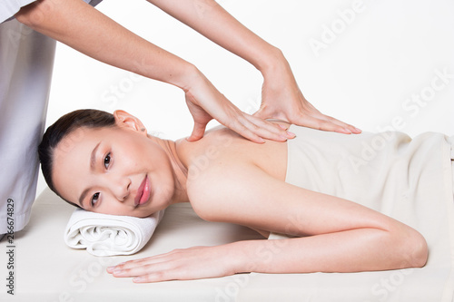 Body Massage on specific naked back of Asian woman by pressing fingers on pain or stress muscle point to release relax. Therapist Spa body massage woman hands treatment on customer, isolated on white