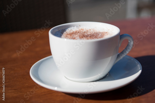 close up cappuccino in white cup and saucer