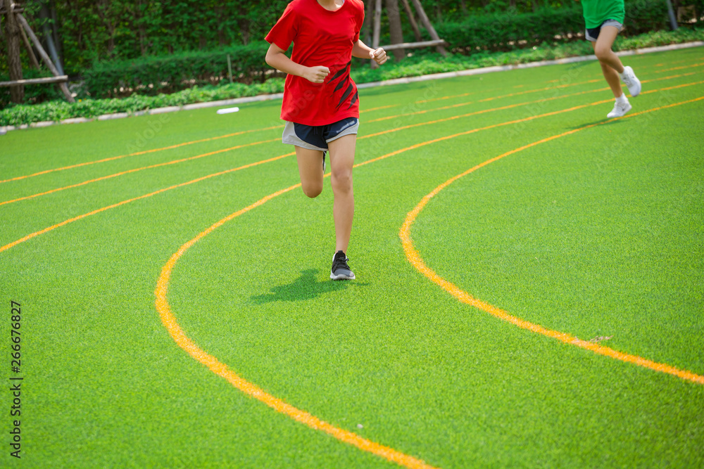 Fototapeta premium young sport girl running on sport field