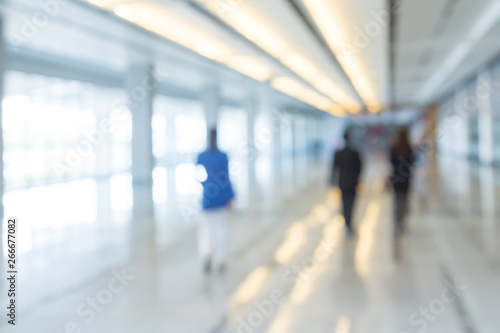 Blurred background of businesspeople walking in the corridor of an business center