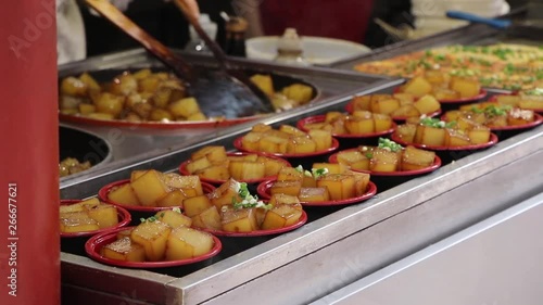 Street food vendors in Asia, frying tofu in a Market, steady shot photo