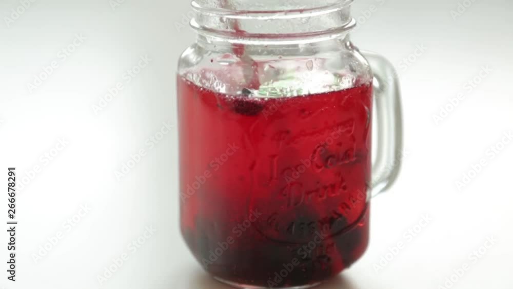 Adding berries and ice to carbonated water. Step by step preparation of cocktails with lemon and orange. Adding berries and ice to carbonated water. Step by step preparation of cocktails with lemon and orange.