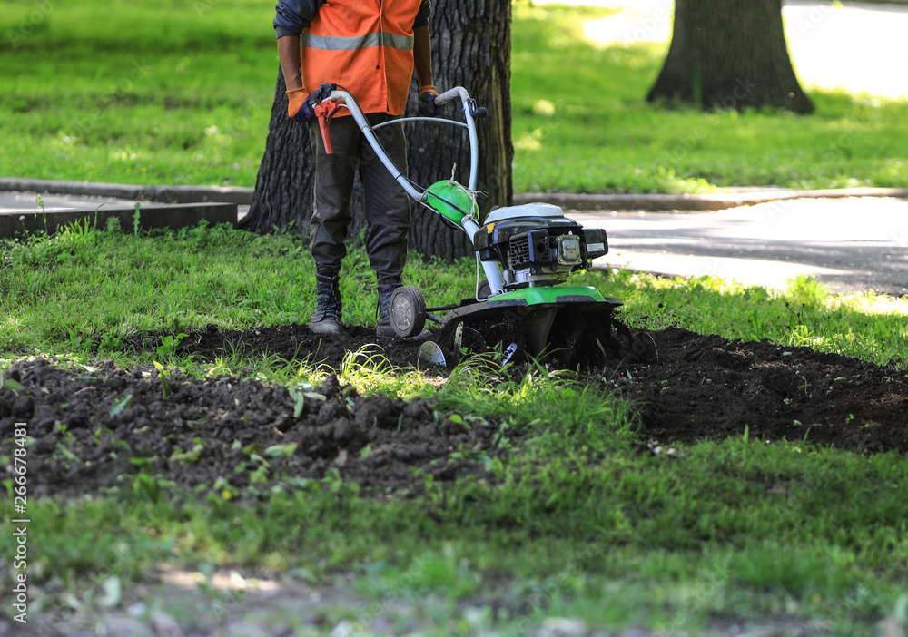 Obraz premium compact earthmoving machine plowing the ground