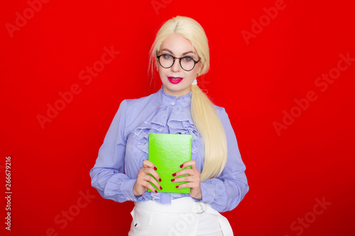 Blondhead female businesswoman smiling in glasses holding notebook photo