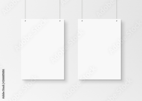 White poster isolated hanging by strings on wall mockup 3D rendering