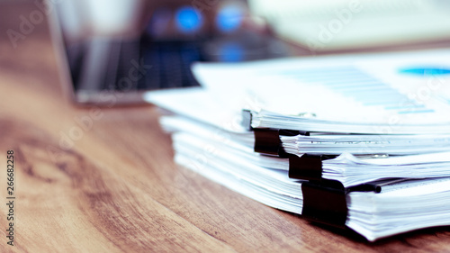 Stack of documents placed on a business desk in a business office.