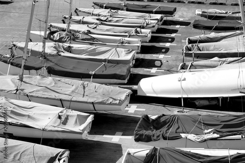 Small sailboats lining the marina's boat yard