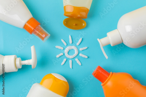 sunscreen remedy. various sunscreens and sun cream on a bright blue background. Sun protection. Ultraviolet protection. Summer. top view. photo