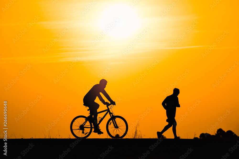 Silhouette man cycling on sunset background