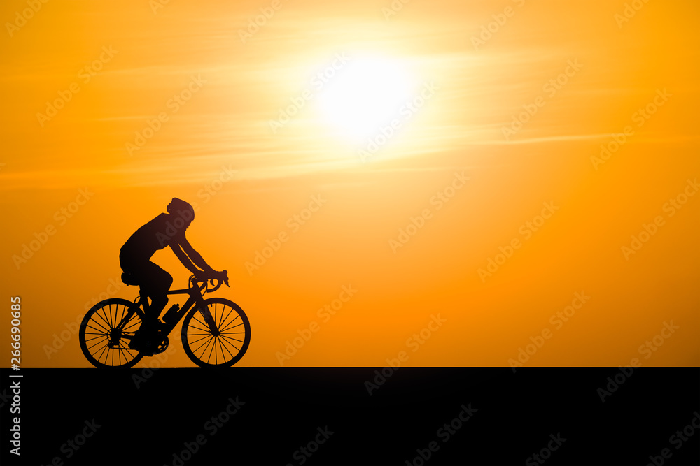 Silhouette man cycling on sunset background Silhouette man cycling on sunset background