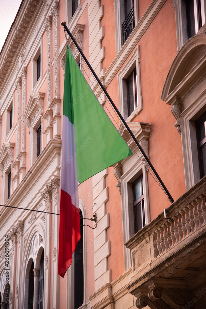 Flag of the Italian nation, white, red, green. Exposed in a historic building, Rome, Italy