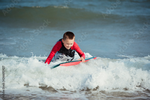 Little Boy Hitting the Surf