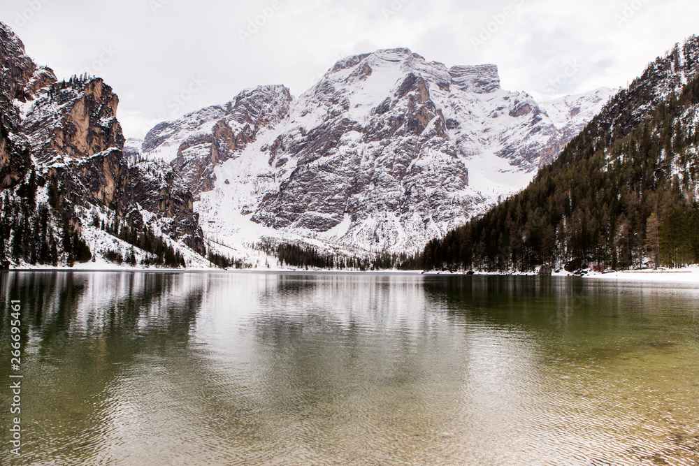 Landscape of Beautiful mountain lake in Alps. Braies Lake in Dolomites mountains. The lake is surrounded by forest. Lago di Braies, Italy.