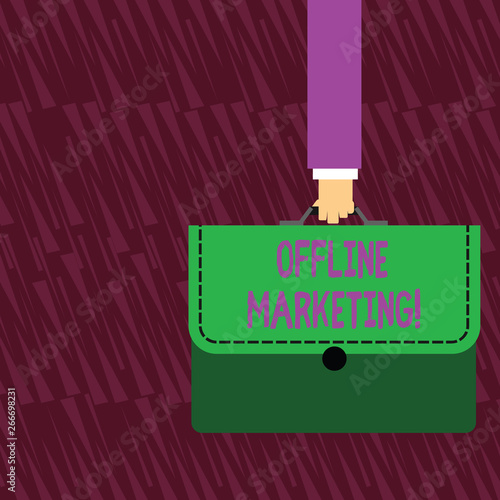 Text sign showing Offline Marketing. Business photo text Advertising strategy published outside of the internet Businessman Hand Carrying Colorful Briefcase Portfolio with Stitch Applique