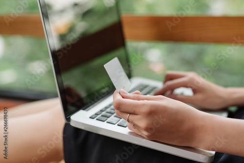 Portrait of a Girl holding credit card and using laptop. Online shopping