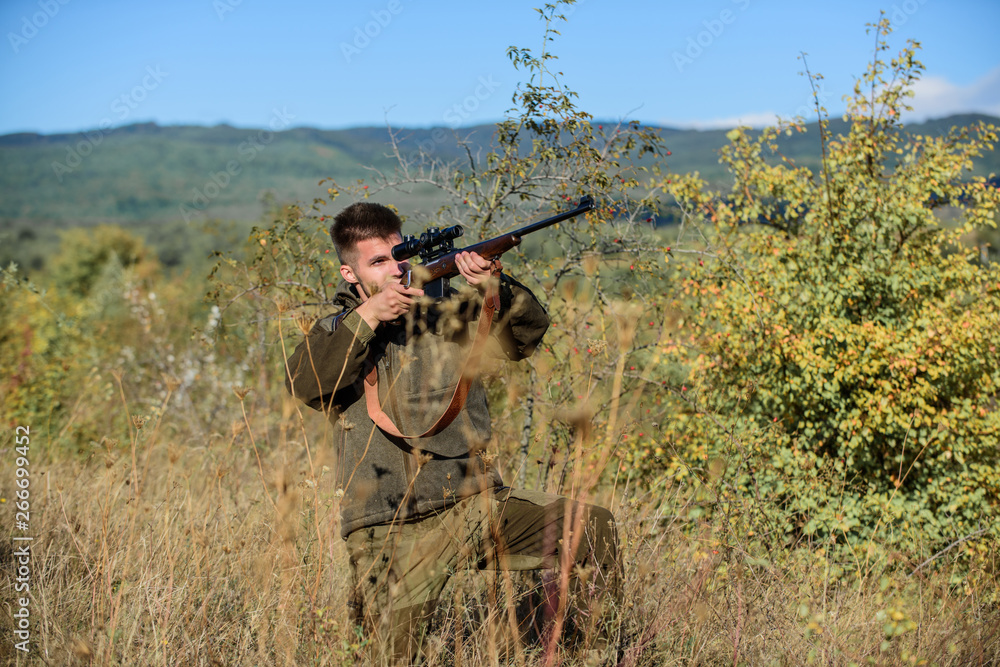 Aiming skills. Hunting permit. Bearded hunter spend leisure hunting. Hunting equipment for professionals. Hunting is brutal masculine hobby. Man aiming target nature background. Hunter hold rifle Aiming skills. Hunting permit. Bearded hunter spend leisure hunting. Hunting equipment for professionals. Hunting is brutal masculine hobby. Man aiming target nature background. Hunter hold rifle
