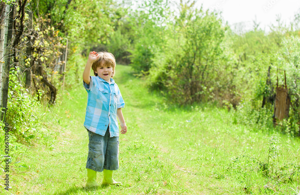 human and nature. earth day. Eco life. summer activity. small kid gardener walking in forest. farming and agriculture. copy space. happy child farmer in rubber boots, spring. New green life human and nature. earth day. Eco life. summer activity. small kid gardener walking in forest. farming and agriculture. copy space. happy child farmer in rubber boots, spring. New green life