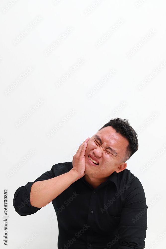 Young man suffering from toothache on white background, closeup Young man suffering from toothache on white background, closeup