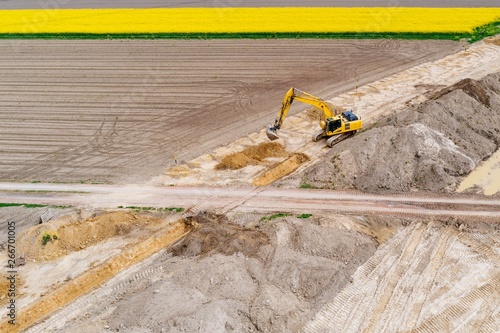 Aerial drone view on excavator working on building site