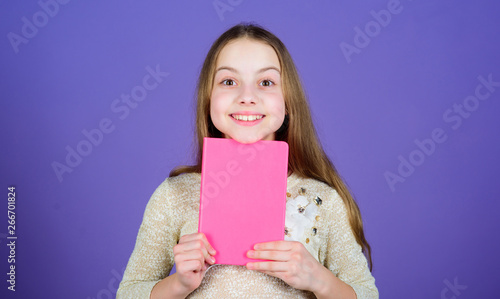 Study what you love and intern in what you want to do. Adorable little girl holding study book with rosy cover. Cute small child with study records. Improving her study skills, copy space photo