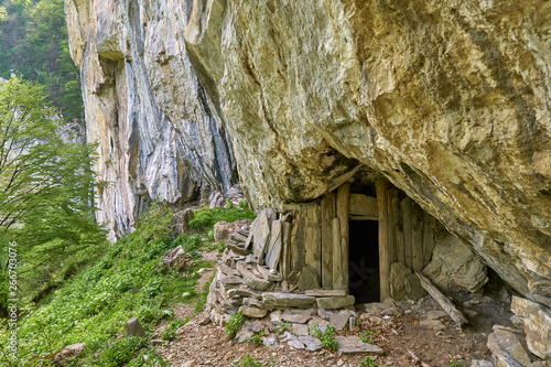 Mountain shelter under rock face