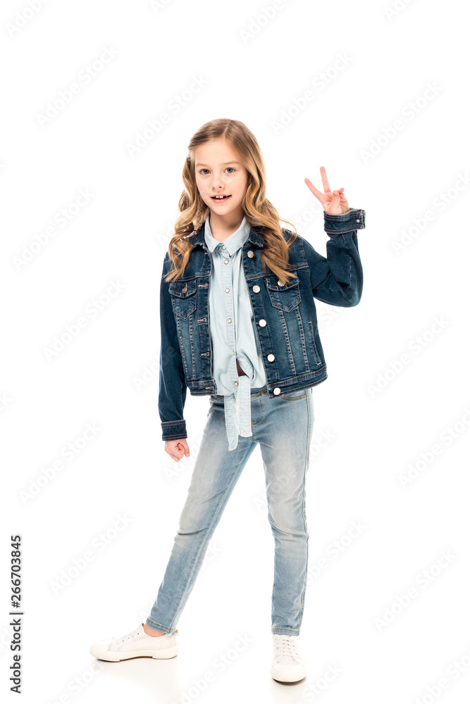 full length view of kid in jeans showing peace sign on white full length view of kid in jeans showing peace sign on white