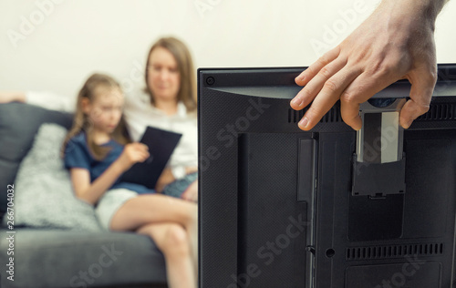 Man installing conditional access module card to TV. photo