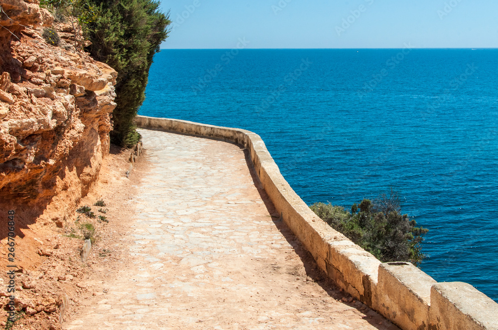 Walkway along the rocks coast and sea